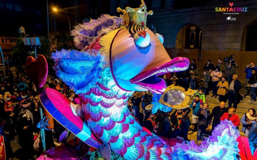 A giant, colorful sardine float wearing a crown during the Burial of the Sardine night parade.
